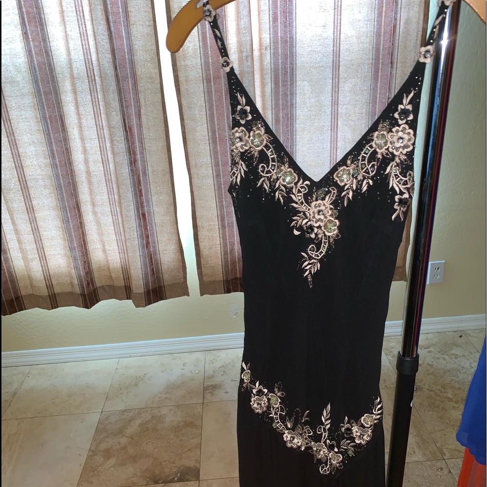 Black dress is with gold embroidery